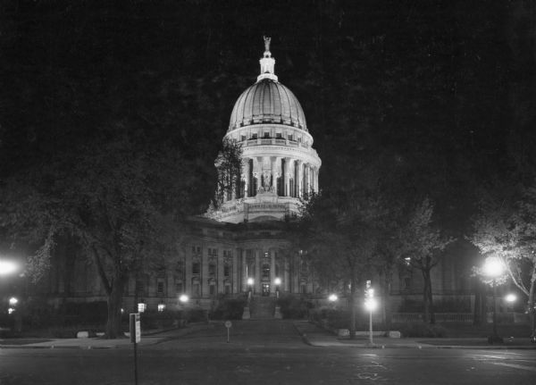 A nighttime view of the Wisconsin State Capitol as seen from Monona Avenue (South Wisconsin Avenue until December 1, 1877; Martin Luther King Jr. Boulevard as of January 19, 1987).