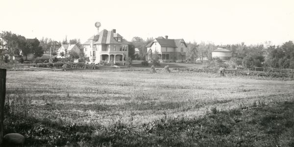 View across field towards two residences of University of Wisconsin Professors. At 1532 University Avenue is the Harry L. Russell home and at 1540 University Avenue, the home of Franklin H. King.