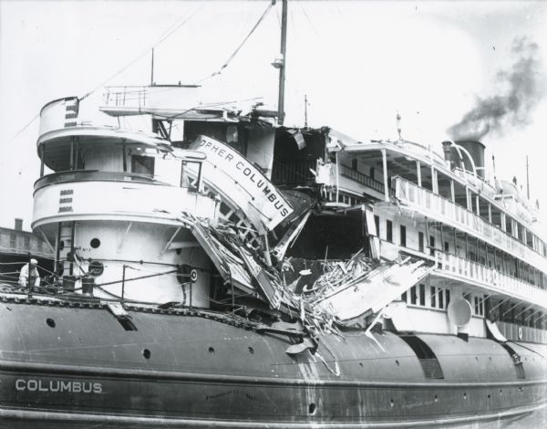 Damaged ship on the Milwaukee River. The <i>Christopher Columbus</i> was a popular cruise vessel launched in 1893 and used to traverse the Great Lakes. On June 30th, 1917, with 413 passengers onboard, the ship was being towed out of the Milwaukee River by tugboats when an unexpected and overwhelming current forced the ship toward shore. The ship collided with a water tower and was demolished. Sixteen passengers died and another 20 were hurt in this freak accident. The <i>Christopher Columbus</i> was repaired and put back into service the following year and sailed the lakes for another 19 years before it was scrapped at Manitowoc, in 1936.