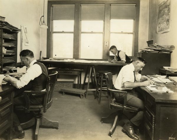 Workers (Mr. R. Kahlor and Mr. V. Downing, Chief Engineer) in the Drafting Room in the Winther Motor Company factory.