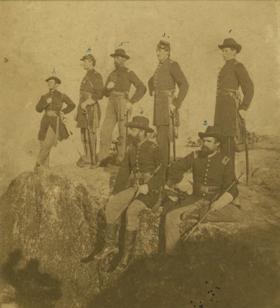 The Twenty-First Wisconsin Volunteer Infantry posing on Lookout Mountain. From right to left: Fred W. Borcherdt of Manitowoc, Wisconsin; acting Adjutant Company D, later Captain of Company E. Albert B. Bradish of Neenah, Wisconsin; First Lieutenant, later Captain of Company L. Rudolph J. Wiesbrod of Oshkosh, Wisconsin; Captain Company E.  Bartholomew J. Van Valkenburg of Two Rivers, Wisconsin; Quartermaster.  John Henry Otto of Appleton, Wisconsin; Captain Company D. Alfred A. Harding of Waupun, Wisconsin, Second Lieutenant Company G. James E. Stuart of Oshkosh, Wisconsin; Captain Company B.