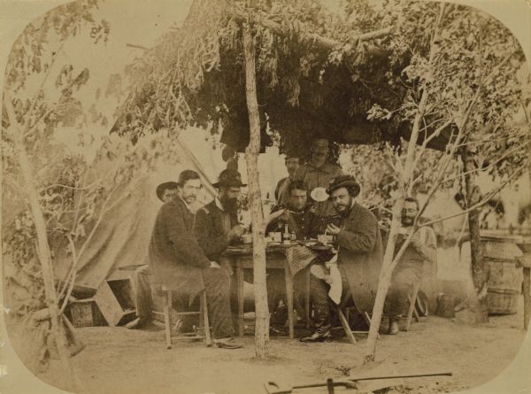 Second Wisconsin Volunteer Infantry officers' mess. Pictured are: Surgeon A.J. Ward, Major Thomas S. Allen, Lt. Colonel Lucius Fairchild, and Colonel Edgar O'Connor, as well as a butler, a cook, and other staff.