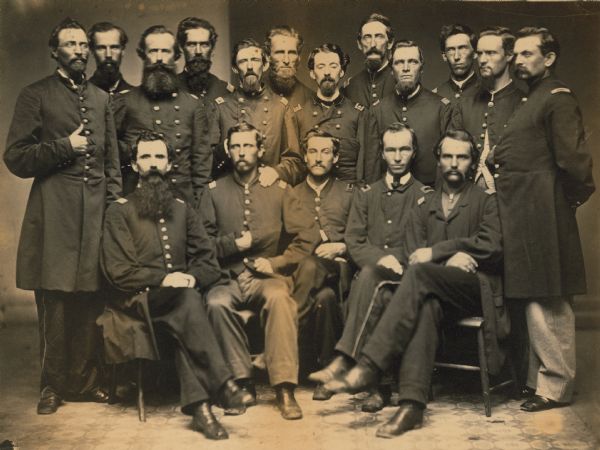 Group portrait of the officers of the 8th Wisconsin Volunteer Infantry. Standing, left to right: unidentified, Lieutenant Doty, Captain James O. Bartlett, Lieutenant Sherman Ellesworth, unidentified, unidentified, Regimental Surgeon Joseph E. Murta, unidentified but known as "Don Quixote," unidentified, Captain Theodore A. Fellows of Genoa, Henry L. Bull, Adjutant Lieutenant Charles Palmetier; seated, left to right: Captain Duncan C. Kennedy, others unidentified.