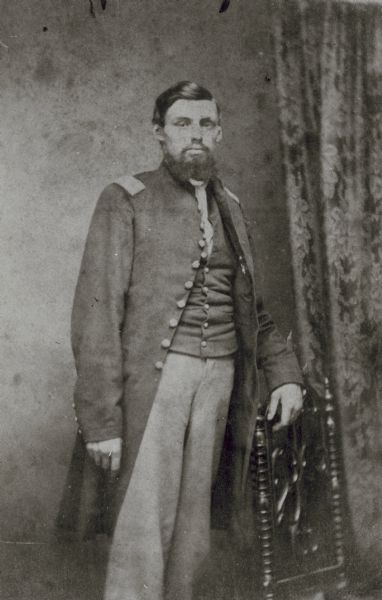 Three-quarter length standing portrait of Lieutenant James B. Pond (later Captain) of Company H, 3rd Wisconsin Cavalry (Reorganized; from original Company C), who won a Medal of Honor for action taken at Baxter Springs, Kansas, 1863.
