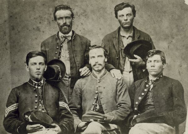 Five members of the 1st Wisconsin Infantry, Company C, who enlisted in 1861, were captured at the Battle of Chickamauga, and escaped together from a Confederate prison. From left to right, standing: Joseph Leach and Lemuel McDonald. From left to right, sitting: Chauncey S. Chapman, Thomas Anderson, and John R. Schofield. This photograph was probably taken after their escape, when they were reunited in Cincinnati at the soldiers' home there.