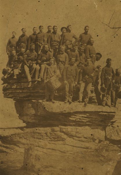 Company D, Twenty-first Wisconsin Volunteer Infantry. Top row (left to right): John Buboltz, Spencer Orlup, J. Henry Otto, Lyman C. Wait, Andrew Jackson, William W. Wood, Joseph D. Holden, Charles Lymer, and Sylvester Greeley; second row, seated: Charles Buck, Miles Hoskins, George Ranson, Nelson B. Draper, Miles H. Fenno, Lewis H. Sykes, and James P. Walker, end of second row, standing: John Dey: front row: Harold Galpin, Jacob W. Rexford, August Pierrelee, Maurice R. Grunert, Ephriam Walker, and Charles Buckholz.