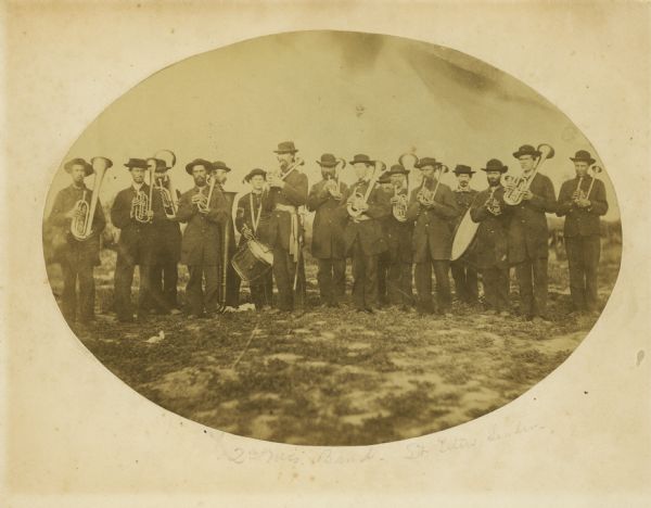 The brass band of the 2nd Wisconsin Infantry.  In the past, the leader in the picture was identified as Hazard W. Titus, but it is likely that this photograph was taken in 1861, before Titus became band leader in 1862. This regimental band saw its membership decrease such that by the beginning of 1862, there were fewer than the 16 men shown here in the band.  It is more likely the leader shown here is band's first leader, Homer S. Chandler, who resigned in October, 1861.