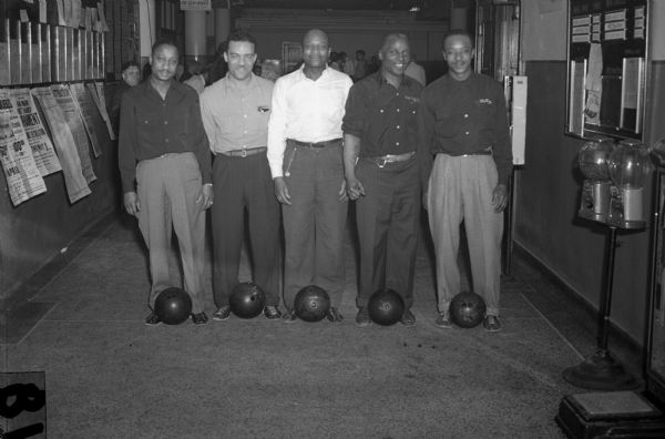 Bronzeville Bombers just after coming through with a score of 2690, putting them in tenth place in the state CIO tournament on April 5.  The five men are all CIO'ers from different plants throughout Milwaukee.  Left to right: Scott Watson, William Tucker, Newt Walton, Percy Akins and Isaiah Pyant. Wisconsin CIO News.

