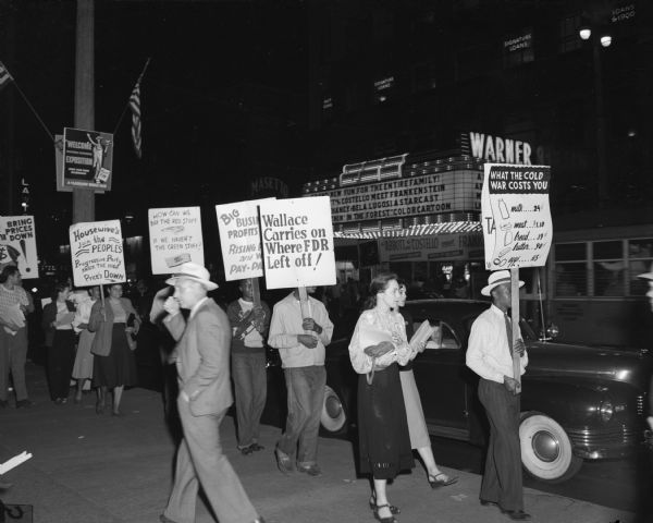 One of the many demonstrations organized by the People's Progressive Party in Milwaukee to fight the ever-rising cost of living. The campaign includes the possibility of a week's boycott on meat and calls for establishment of city-run milk distributions, among other features.  A number of such demonstrations have taken place in different parts of the city. This one was on Wisconsin Avenue in the heart of the downtown area.
- Wisconsin CIO News  
