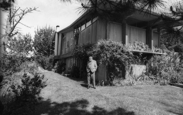 Ansel Adams stands outside his home.