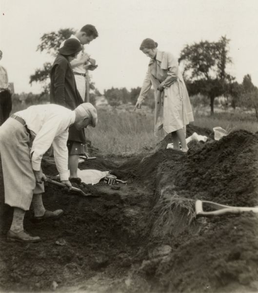 W.P. and Vivian Morgan, Grace Rollins and ? Mills excavate a burial mound in the Outlet group at the foot of Lake Monona.