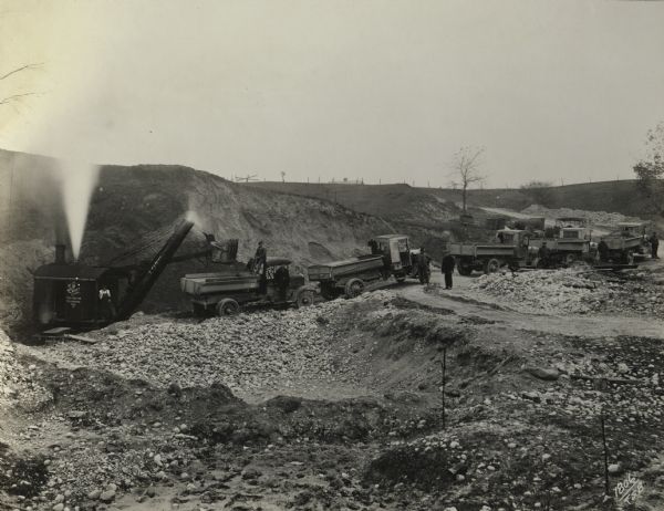 Dump trucks and steam shovel of the S.P. Croft Company, a road contractor from Milwaukee, at work at an unidentified Wisconsin site.