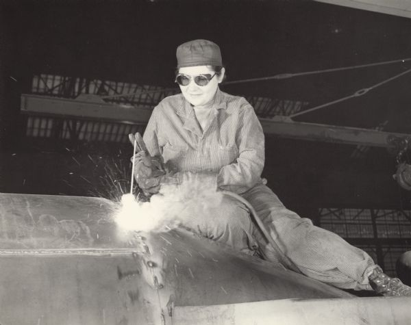 Enola O'Connell, the only woman welder at the Heil Company during World War II, working on gasoline trailer tanks.  A 32-year-old widow and the mother of one child, her job at Heil was her first work outside the home.