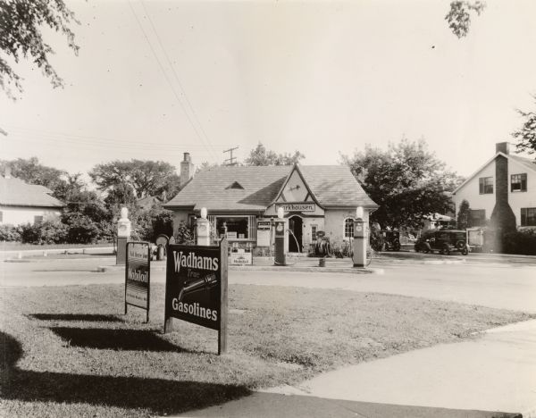 Gas station. The Tudor-revival style of this station represents gas station owners' trend to adopt domestic architectural styles as they moved into residential neighborhoods.  Also typical is the fact that the station sits at an angle of a street intersection in order to better attract customers driving in both directions.  This station is one of a Green Bay chain owned by Henry Barkhausen.