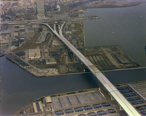 The bridge over the Milwaukee Harbor named in honor of former Mayor Daniel Hoan. The bridge was constructed between 1970 and 1972, but during the period depicted here, it was a "bridge to nowhere" because of local backlash against the Milwaukee freeway system. The bridge finally opened in 1977 as part of the route of I-794. In 2000 the Hoan Bridge was again in the news when several girders cracked as a result of outmoded bridge joint design, extreme cold, and heavy trucks. The bridge reopened on October 31, 2001.