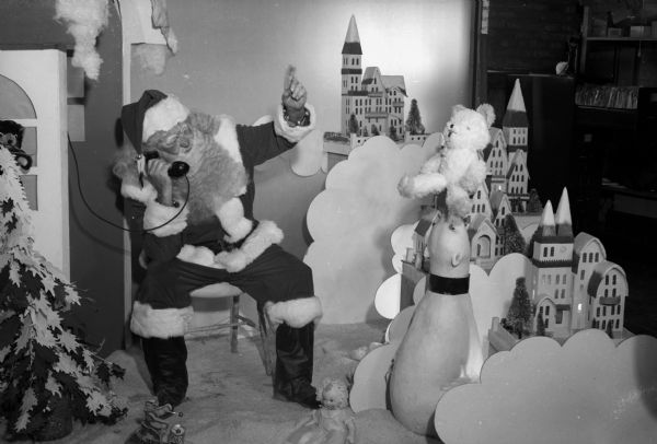 Santa Claus talks on a telephone at a Christmas display at Manchester's Department Store.