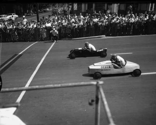 Two racers speed away from the starting ramp at the Soap Box Derby held on East Washington Avenue starting at the Wisconsin State Capitol.