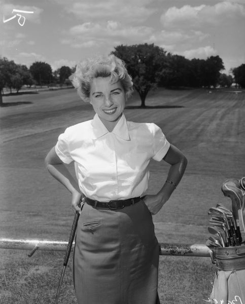 Unidentified woman golfer posing outdoors at the Maple Bluff Country Club.