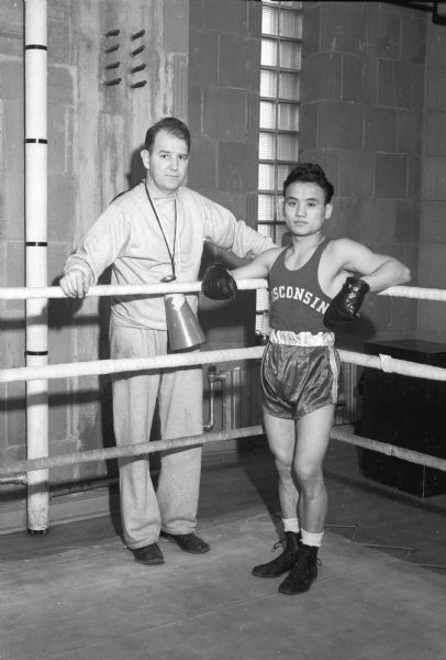 Japanese boxer, Dick Miyagawa, with University of Wisconsin boxing coach, John J. Walsh. Miyagawa was the national collegiate champion in 1942 when he competed for San Jose State. Later he boxed for the University of Wisconsin.