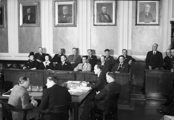 Jury members and lawyers from the trail of Arthur M. Joys.  Seated at the defense table are (left to right): defense attorney Darrell MacIntyre, defendant Arthur M. Joys, and district attorneys Joseph Gamroth and Norris Maloney.  The trial resulted in a not-guilty verdict by reason of insanity. Joys was accused of an assault upon his daughter Joan with a hammer and butcher knife.