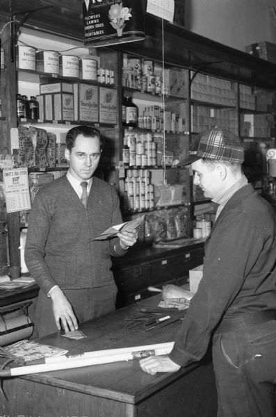 Alvan Rothermel, Glen Oak Hills, purchasing seed, labels and tools, for his Victory garden from Louis Schuster, manager of the L.L. Olds Seed Company, 720 Williamson Street.