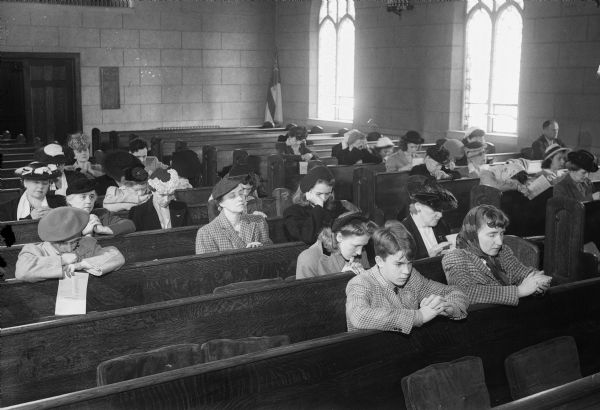 Friends and relatives of service men and women participating in prayer at St. Andrew's Episcopal Church for the D-Day Invasion forces.