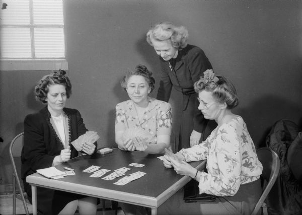 Participating in the annual Woman's Club benefit party are Shorewood Hills League members, left to right: Mrs. Walter (Clare) Weissinger, 1241 Sweet Briar Road, general chairman of the party; Mrs. Willbur. S. (Josephine) Grant, 3452 Crestwood Drive, head of the reception committee; Mrs. Nathaniel (Ann) Huggins, 3266 Tally Ho Lane, head of the prize committee; Mrs. Donald W. (Edith) Tyrrell, 3510 Blackhawk Drive, chairman of the refreshment committee.