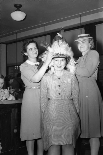Cub Scout Den Mothers Den Mothers Mrs. D.E. (Lenice K.) Arnold, left, and Mrs. E.M. (Mildred F.) Downey, are putting the final touches on the Indian headdress, worn by Mrs. E.J. (Josephine) Terry.