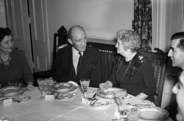Lord Halifax and Mrs. Walter (Madge) Goodland conversing at dinner.