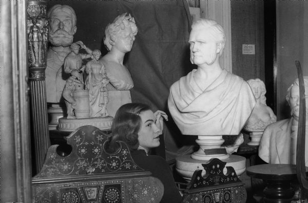 Ruth Marson with the Vinnie Reem sculpture collection in a storeroom at the Wisconsin Historical Society Library.