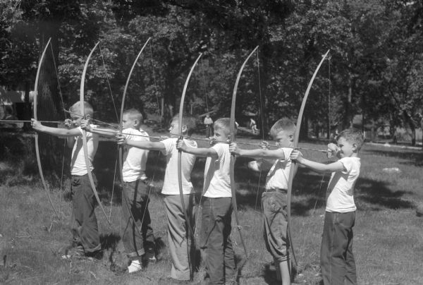 Six young archers at YMCA Camp Wakanda. Left to right: Lowell Hugo, John Stuhlldreher, James Treadwell, Walker Johnson, Tommy Bergmann and John Lonergan.