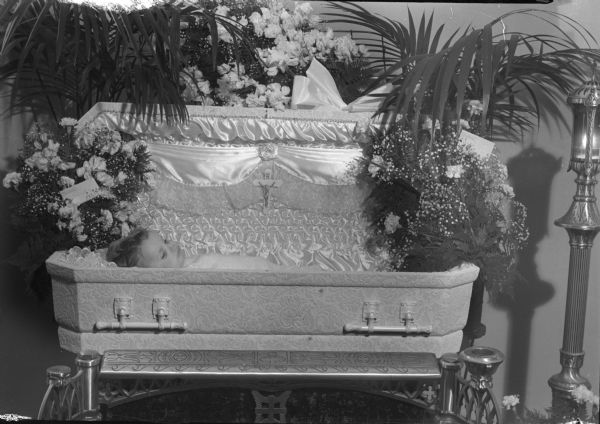 William E. Crossen, eighteen-months-old, son of Mr. and Mrs. Phillip Crossen, shown in a coffin at Joyce Funeral Home.