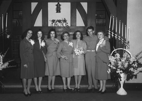 Wedding party of Virginia M. Parker and Sgt. Lawrence E. Gooding, Jr., with their mothers in front of the altar at Blessed Sacrament Church.