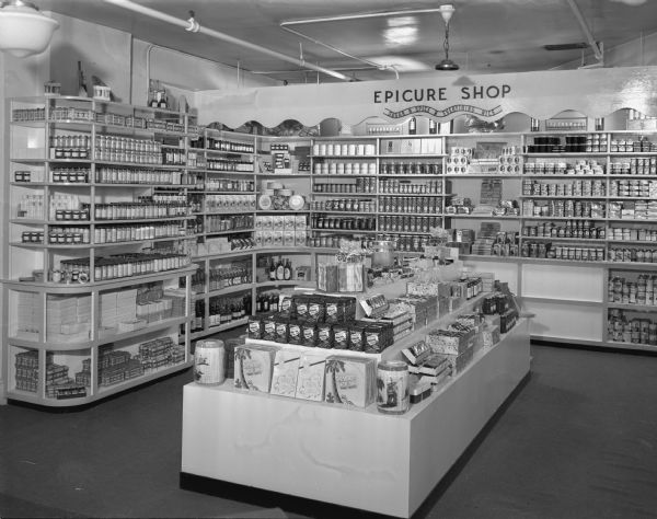 Baron's Epicure Shop Interior view of the Epicure Shop in Baron Brothers department store, 14 West Mifflin Street, showing display counters and shelves. The Epicure Shop sold herbs, salad ingredients, party accessories and candies.