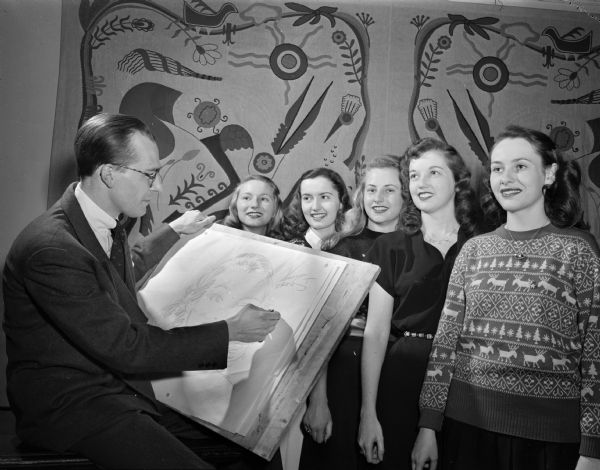 Cartoonist Ken Ernst and five University of Wisconsin  Badger Beauties, one of whom he will select to be cast as one of the characters in his "Mary Worth" comic strip.  The woman are, left to right:  Virginia Freund; Alberta Baxter; Bette Lami; Marilyn Moevs; and Ruth Schmitt.