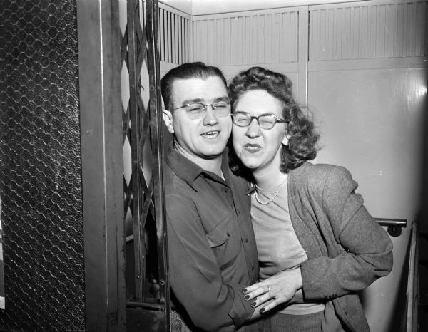 Joe Dommershausen and Hilda are shown cheek to cheek with eyes closed in the elevator in the Wisconsin State Journal building.