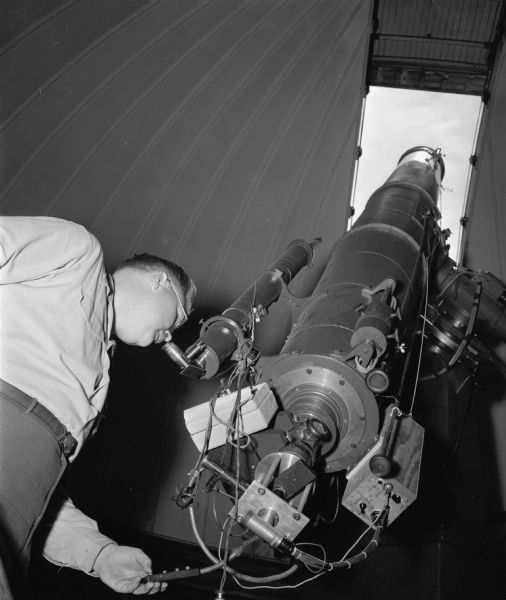 View looking up towards open dome as Olin Eggen, research astronomer, looks through the telescope at Washburn Observatory on the campus of University of Wisconsin-Madison.