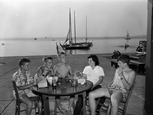 A few of the children of Mendota Yacht Club members, seated on the terrace at the James Payton house, 409 N. Blair Street. Left to right: Mark Nesbit, Jimmy Schneiders, Tory Stebbins, Janet Donovan, and Cameron Adams.