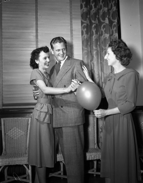 Ann F. Warren, cutting in on Kathleen and Calvin Royston during the balloon tag dance at the Woman's Club Building, 240 West Gilman Street.