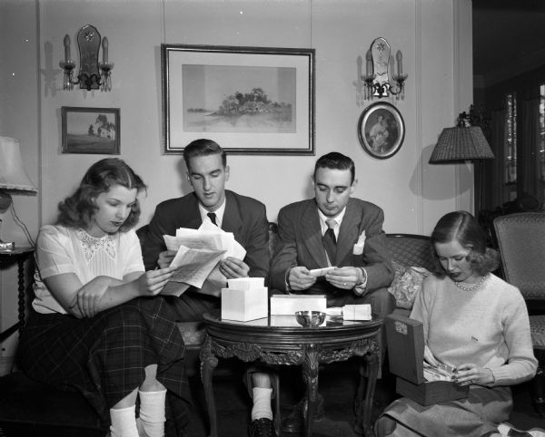 Four young Madisonians working on arrangements for the second annual Christmas subscription ball. L to R: Carol Sisk, Robert Samp, Max Dunn and Virginia Rayne.