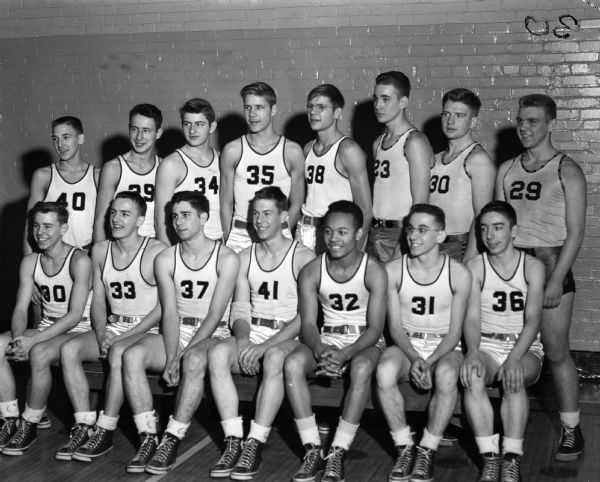 Group portrait of Central High School boys basketball team in uniforms.