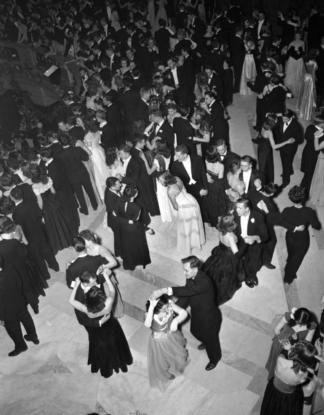 Elevated view of dancers at the University of Wisconsin-Madison Junior Prom held at the Wisconsin State Capitol. The prom was the first one to be held at the Capitol since 1928. Lawrence Welk's orchestra provided the music for the large crowd.