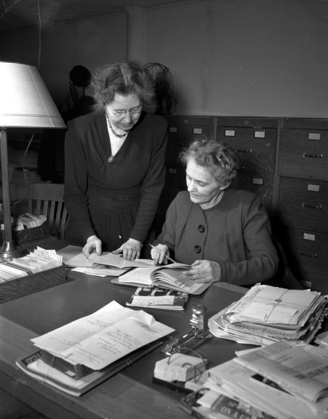 University of Wisconsin Extension's new quarters for the department of discussion and public discussion. Workers Mrs. Marion West and Ruth Rowland are shown as they work in the quarters on University Avenue.