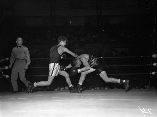University of Wisconsin boxer John Lendenski, left, missing with a right punch to University of Maryland boxer Ed Rieder. The two men are participating in the middleweight championship bout of the NCAA championship being held at the University of Wisconsin-Madison Field House. The winner was Ed Rieder.