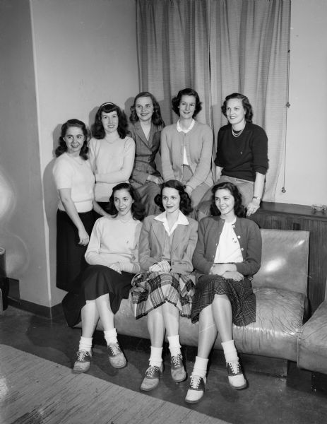 Group portrait of the committee making arrangements for the "Senior Swingout," one of the traditions of the commencement season at the University of Wisconsin-Madison. Seated in the front row left to right: Diane Dodd, Detroit, Michigan, chairperson of arrangements; Barbara Myers, Ossining, New York, general chairperson, and Marilyn McCrory, Wauwatosa, assistant general chairperson. Standing left to right: Gene Bliss, 2714 Chamberlin Avenue, promotions chairperson; Patricia Powell, Wauwatosa, daisy chain charperson; Sylvia Fudzinzki, West Allis, publicity chairperson; Philippa Warburg, Milwaukee, program chairperson, and Margaret Blunt, Richmond, Virginia, marching chairperson.