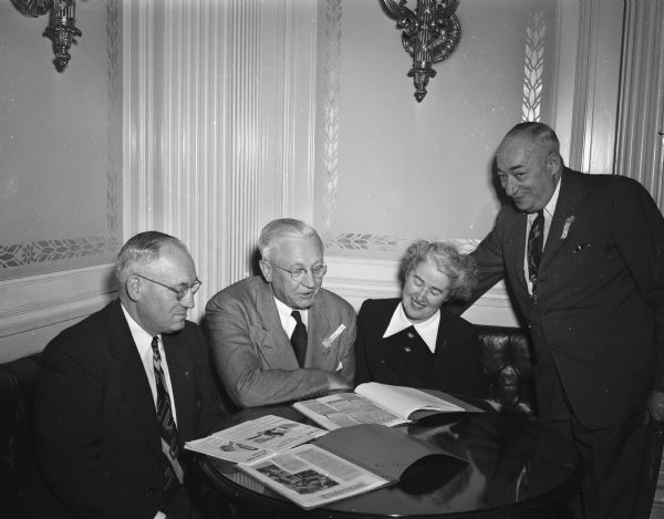 Governor's Commission on Human Rights in the governor's office at the Wisconsin State Capitol discussing plans for an upcoming meeting. Pictured from the left are: Judge Fred Evans, commission chairman; Governor Oscar Rennebohm; Mrs. Rebecca Barton, consultant; and S.L. Goldstein, secretary. Topics on the agenda include reports of mistreatment of migratory workers in Door County and other complaints of discrimination.