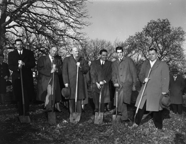 Participants in the ground breaking ceremonies for the new Calvary Gospel church located at 3822 Mineral Point Road. Men standing with shovels, are, from left: Rev. Vernon R.A. Johnson, pastor; Emery Oliver, charter member and Sunday school superintendent; Henning K. Johnson, charter member; Raido Wysong, assistant Sunday school superintendent; Paul Morris, Sunday school teacher; and Rev. F.J. Ellis, Milwaukee, pastor of Elim Tabernacle.
