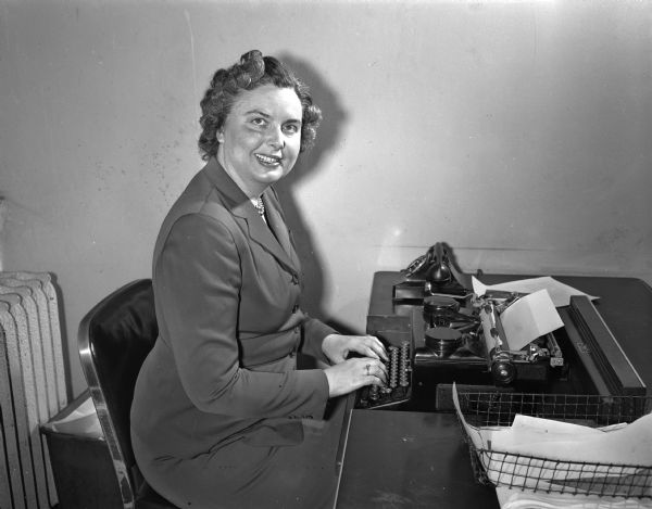 Portrait of Society Editor Louise Marston, at her desk at the Wisconsin State Journal.