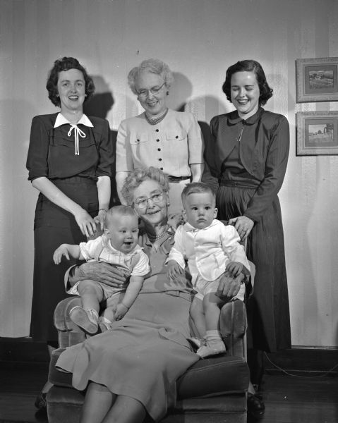 Four Generation Family Portrait Eighty-one year old Mrs. William Morrisey holds her two great-grandsons, Frederick George Joachim, Jr. (left), and John Wolfe. Behind her is her daughter, Mrs. Grover F. (Rose) Kennedy, flanked by her two daughters, Mrs. Frederick G. (Kath) Joachim (left) and Mrs. Robert W. Wolfe of Shorewood, Wisconsin.