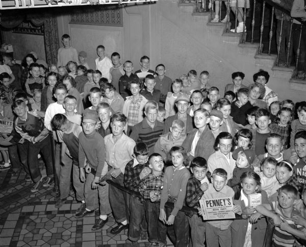 J.C. Penney Back-to-School Party A crowd of school children waits in the lobby of the Capitol Theatre to see the "Back-to-School" party sponsored by the J.C. Penney Company. Free tickets were distributed by the department store for the show which included color cartoons, comedies and a Blondie film.